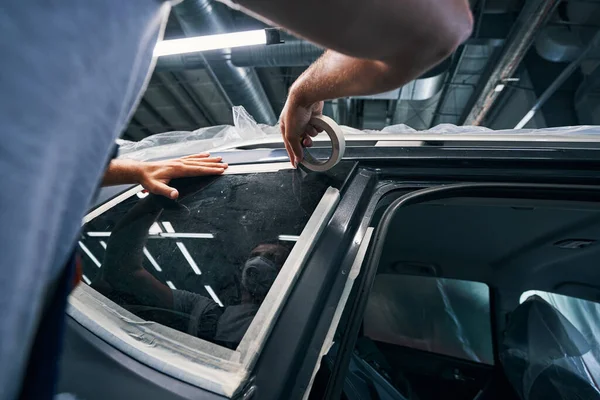 Reparador aislando ventanas de coche con cinta aislante — Foto de Stock