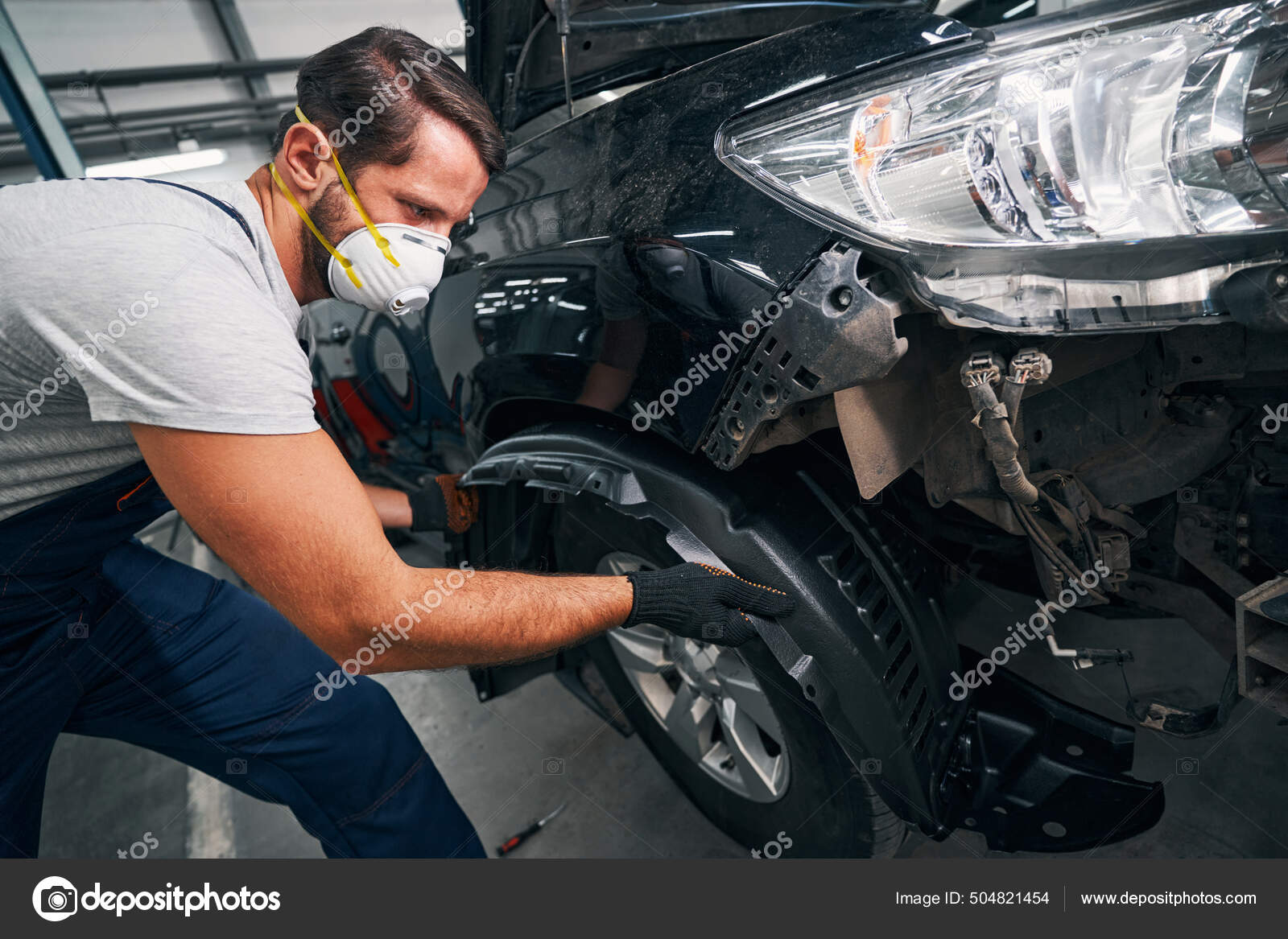 Man pulling out car wheel arch cover Stock Photo by ©yacobchuk1 504821454