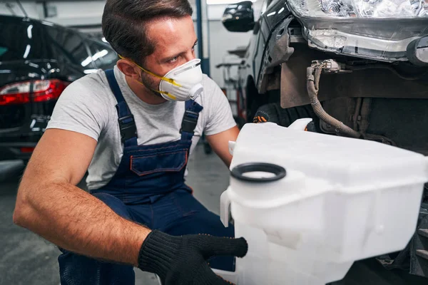 Washer bottle in hand of car technician — Stock Photo, Image