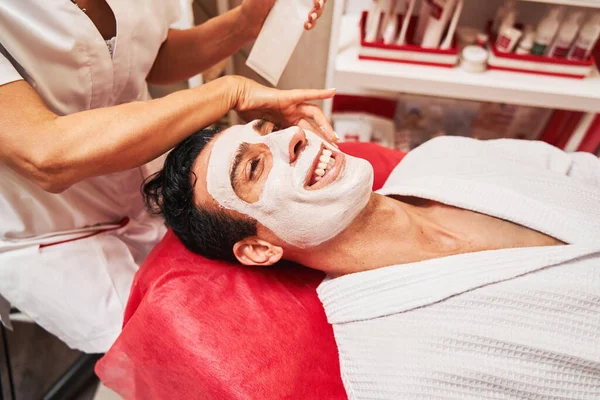 Kosmetika zákazník usmívá během ošetření pleti obličeje — Stock fotografie