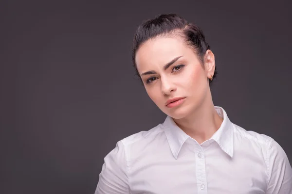 Serious woman wearing white blouse — Stock Photo, Image