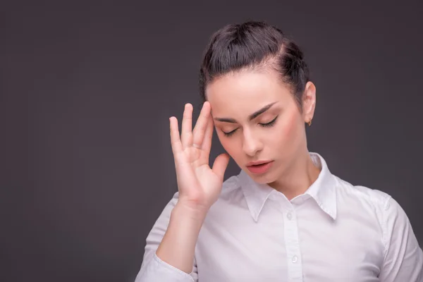 Serious woman wearing white blouse — Stock Photo, Image