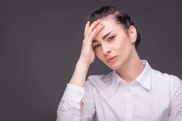 Serious woman wearing white blouse — Stock Photo, Image