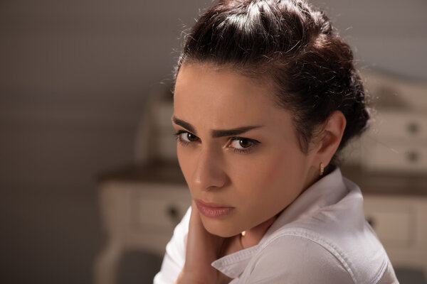 Serious woman wearing white blouse