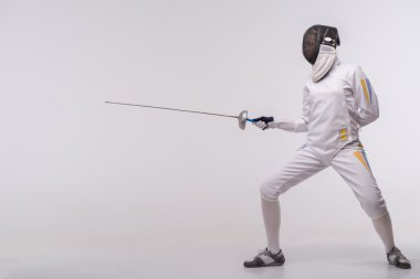 Young woman engaging in fencing clipart
