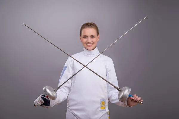 Young woman engaging in fencing — Stock Photo, Image