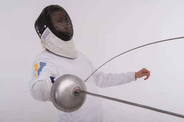 Young woman engaging in fencing — Stock Photo, Image