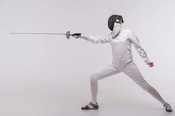 Young woman engaging in fencing — Stock Photo, Image