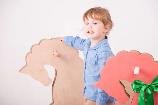 Kind met het speelgoed paard — Stockfoto