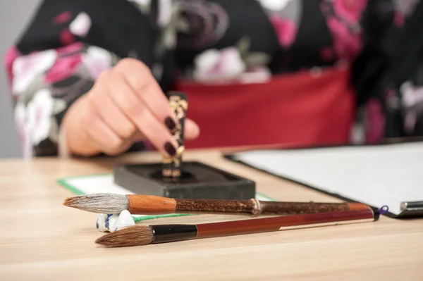 Caligrafía tradicional sobre mesa de madera — Foto de Stock