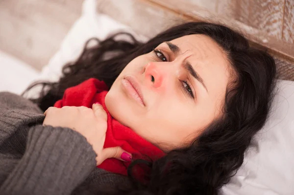 Young sick girl lying in bed — Stock Photo, Image