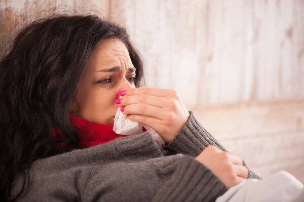 Young sick girl lying in bed