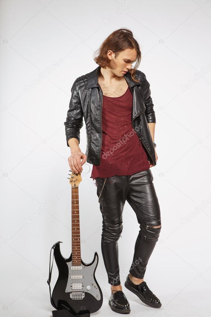 Young guitar player isolated on grey