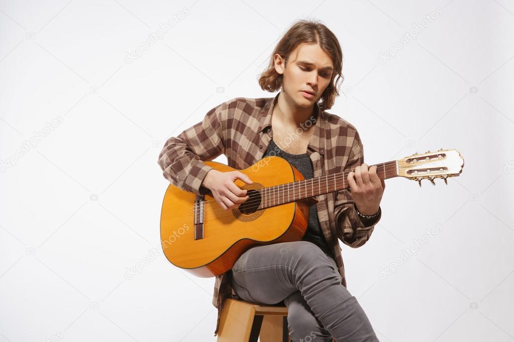 Young guitar player singing a song