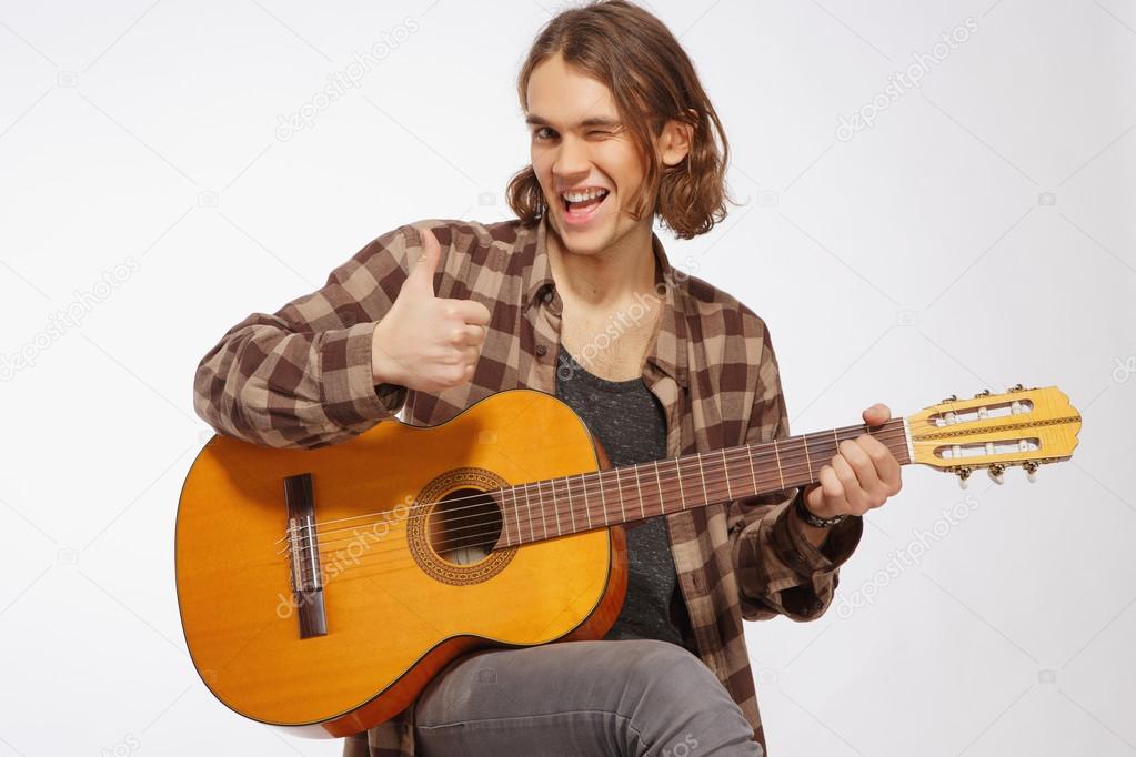 Young guitar player singing a song