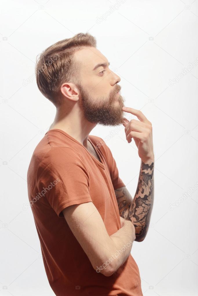 Handsome bearded man posing on white