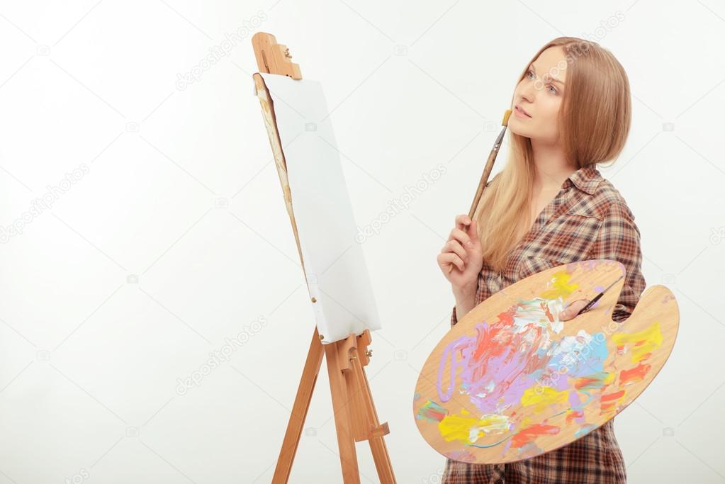 Young beautiful artist creating a masterpiece