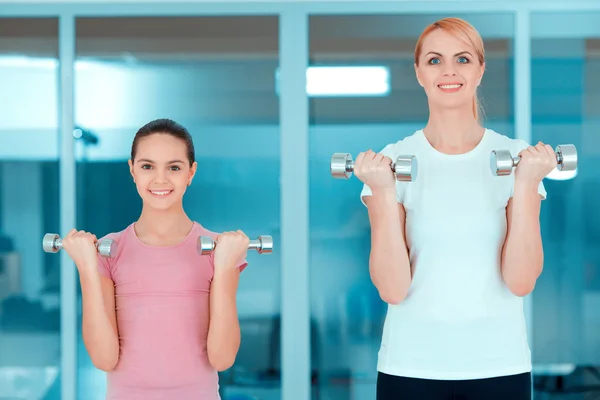 Mother and teenage girl at sports club