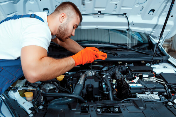 Car mechanic at the service station