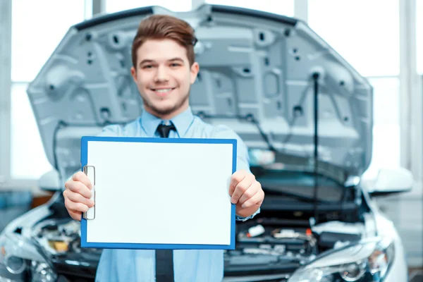 Car service manager posing with a clipboard Stock Image