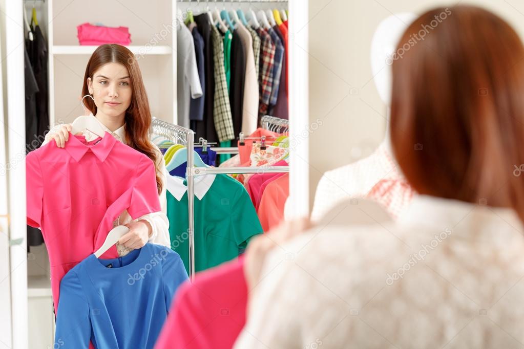 Woman chooses blouse in a store