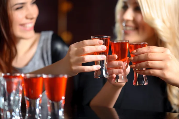 Three women have a drink in the bar