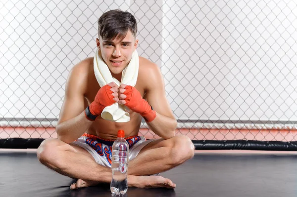 Sportsman with water and towel — Stock Photo, Image