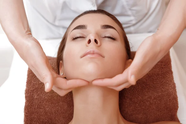 Beautician makes face massage — Stock Photo, Image
