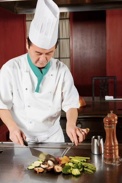 Cook prepares fried vegetable dish — Stock Photo, Image