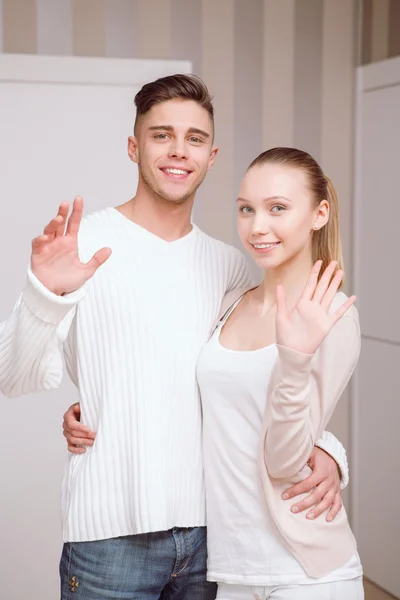 Young couple standing and greeting — Stock Photo, Image