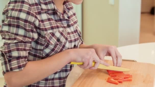 Ung kvinna skär paprika — Stockvideo