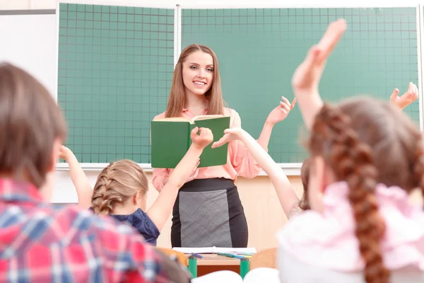 Pupils raising their hands during classes — Stock Photo, Image
