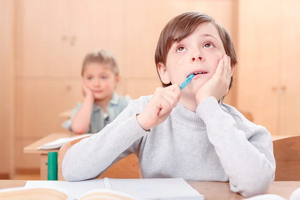 Thoughtful little boy during classes — Stock Photo, Image
