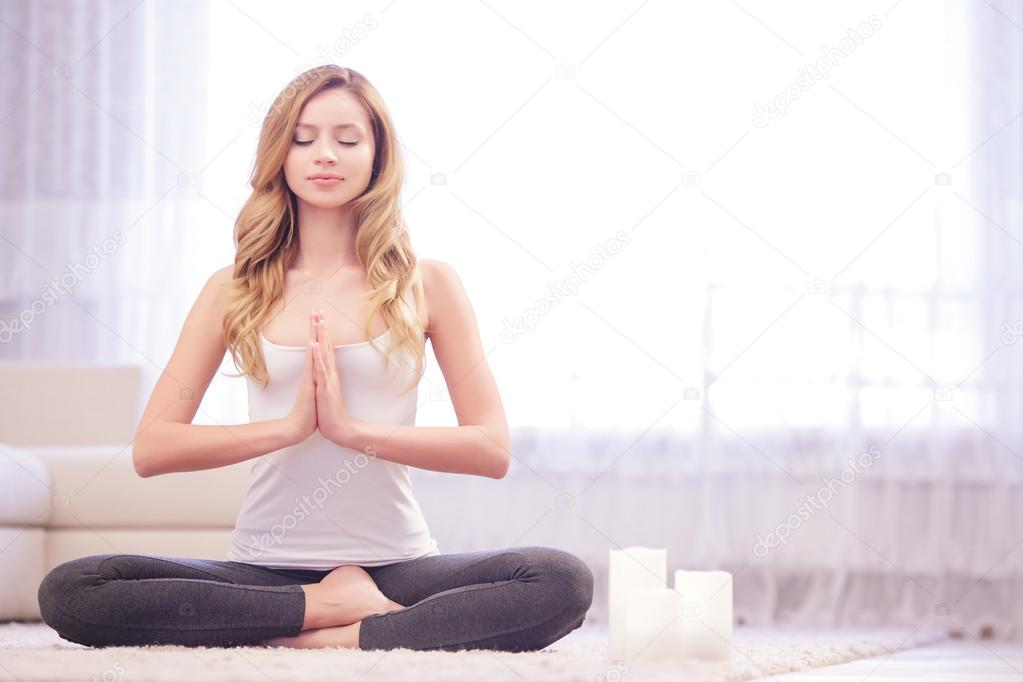 Young woman sitting and meditating