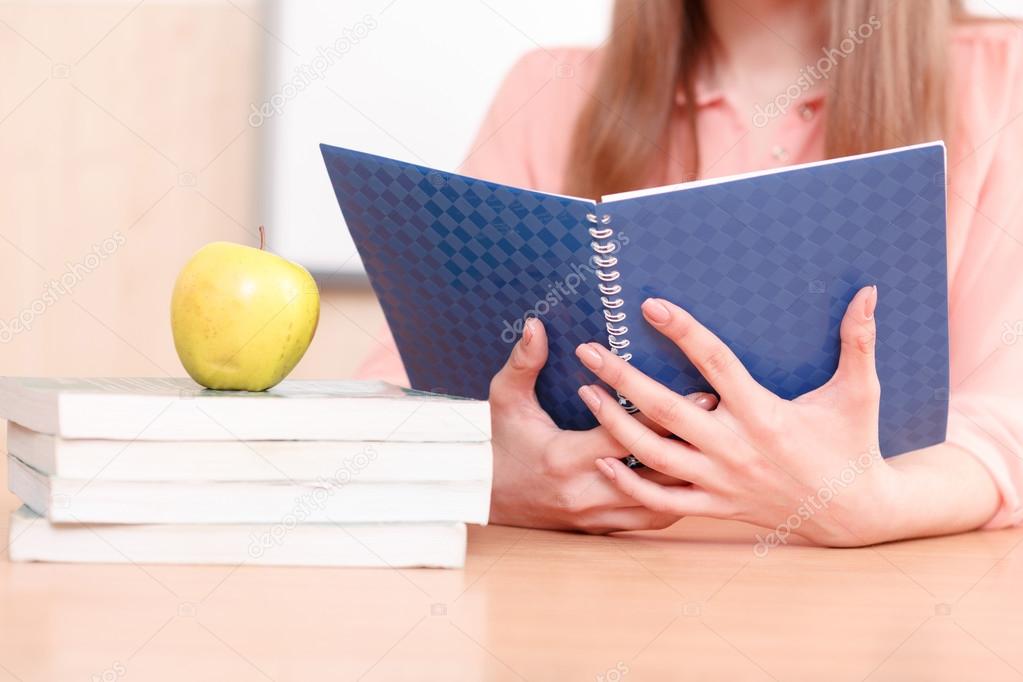 Woman holding blue copy book