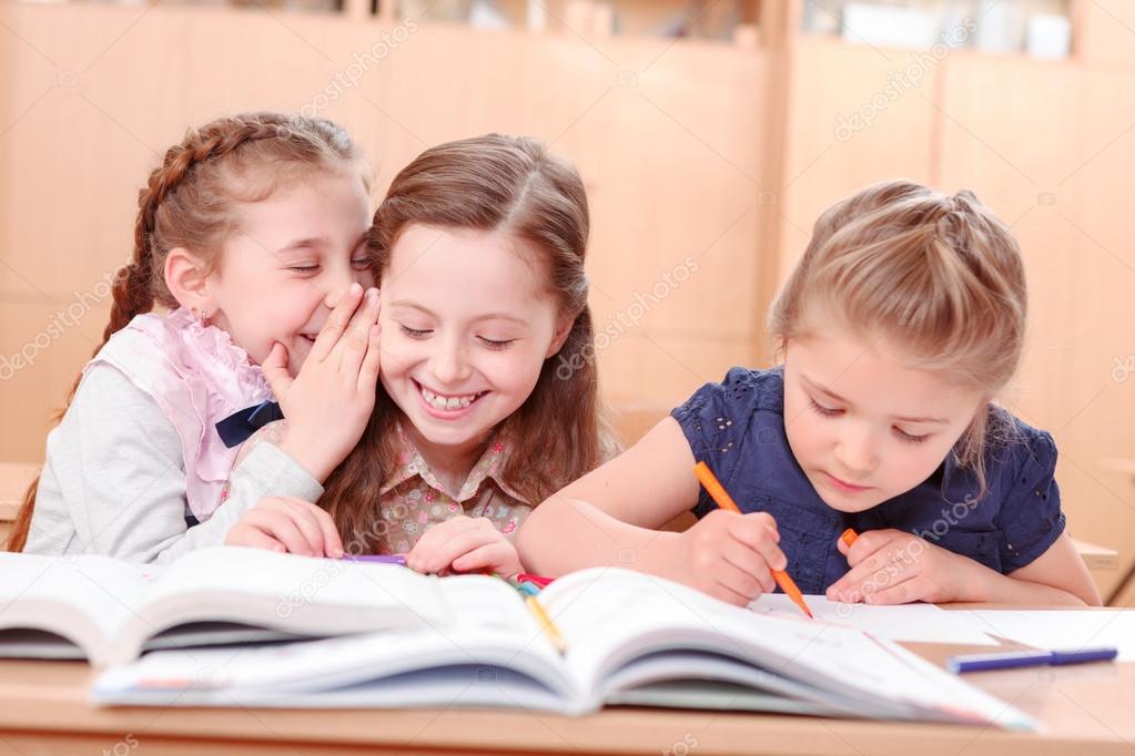 Girls with opened books in classroom