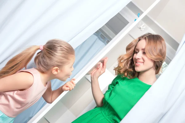 Klein meisje op zoek naar haar moeder binnen een paskamer — Stockfoto