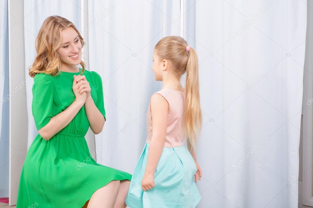 Young mother and her daughter in a fashion store