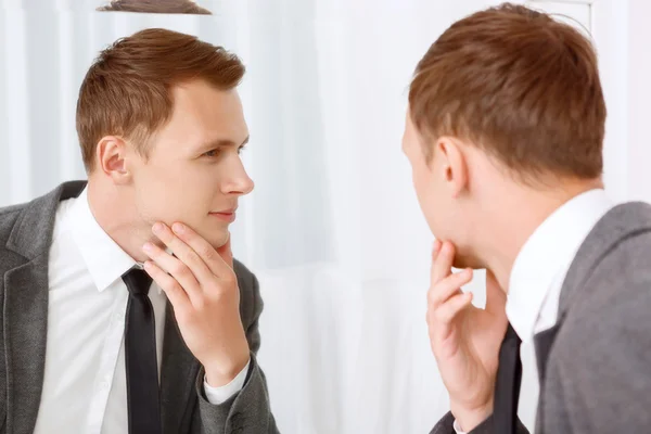 Young man checking his bristle hair on face — Stock Photo, Image