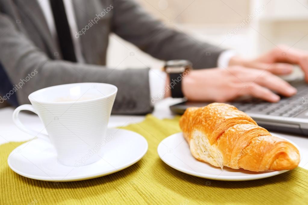 Close up of croissant and cup coffee.