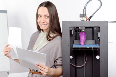 Beautiful girl with three-dimensional printer  clipart
