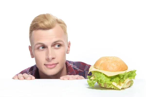 Close up of young man looking at sandwich — Stock Photo, Image