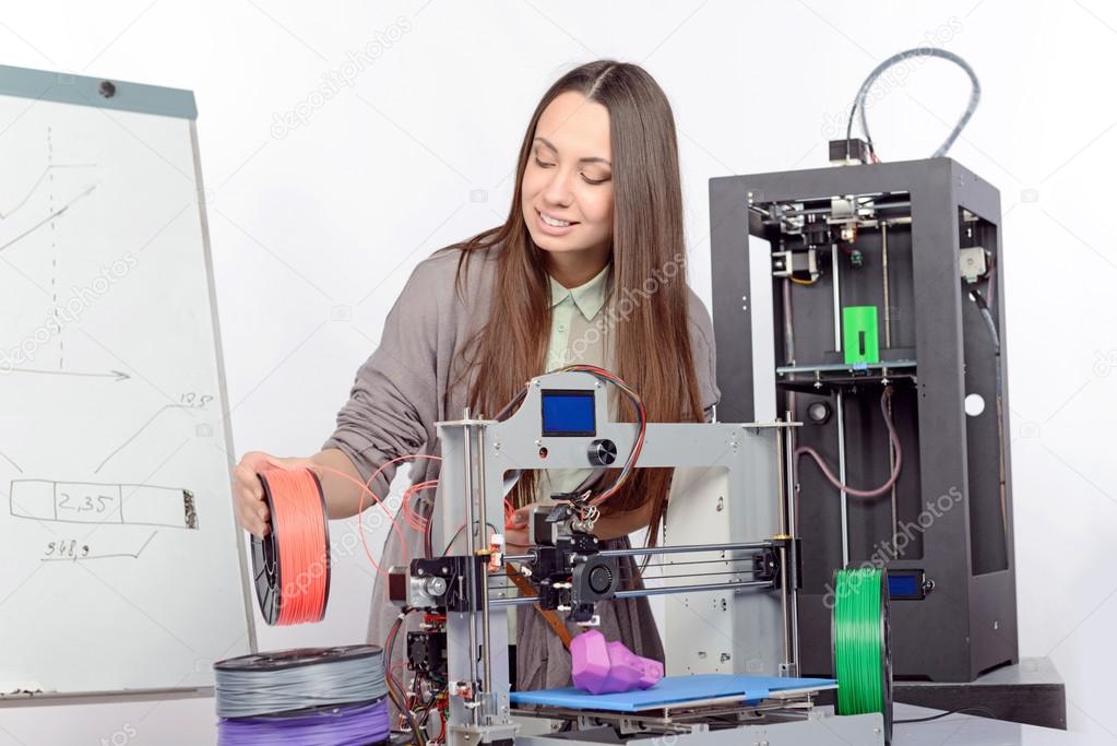Beautiful girl with three-dimensional printer 