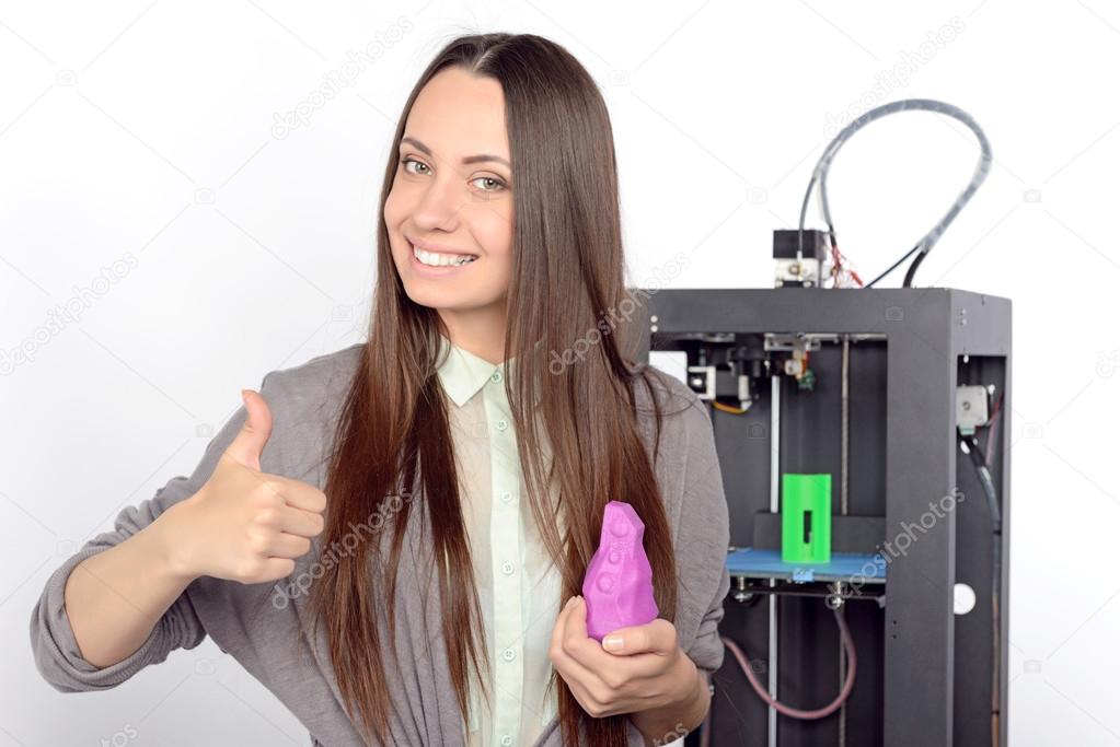 Beautiful girl with three-dimensional printer 