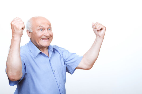 Laughing grandfather holding hands up