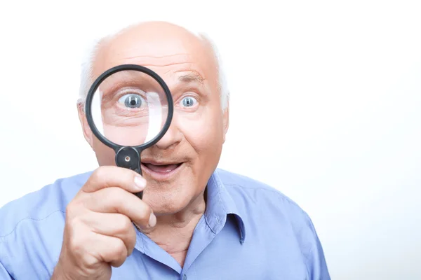 Agreeable grandfather keeping loupe — Stock Photo, Image