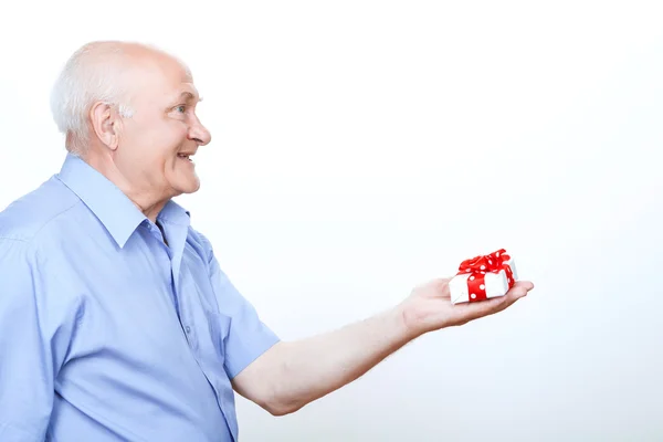 Positive grandfather holding the present — Stock Photo, Image