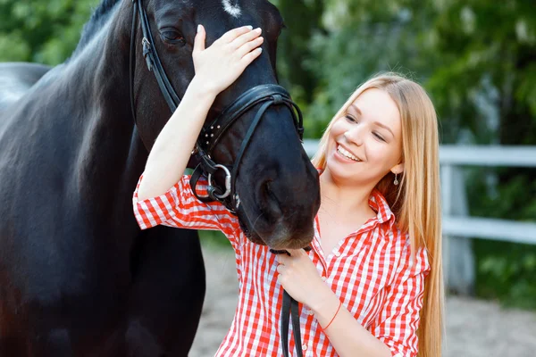 Nice girl palming purebred horse — Stock Photo, Image