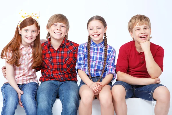 Smiling friends sitting together — Stock Photo, Image