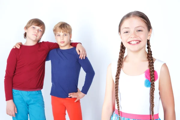 Smiling girl with two boys — Stock Photo, Image